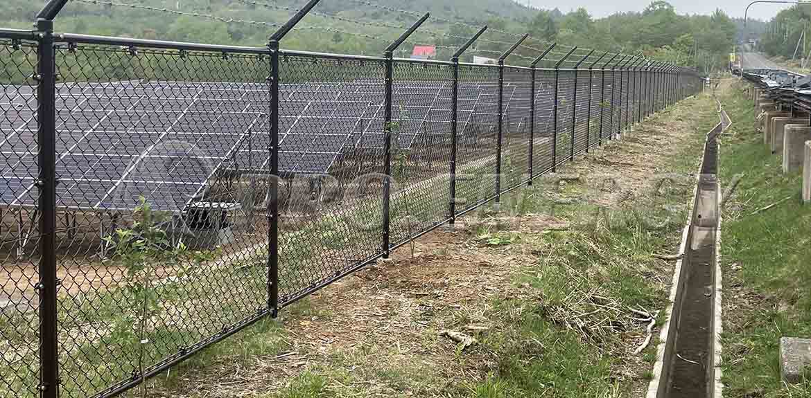 Brown Chain Link Fence with Anti-Climb Spikes – Power Plant Perimeter Security Solution